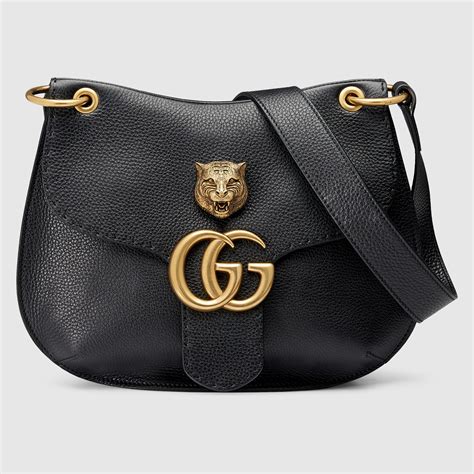 Shop the Black Leather GG Marmont Small Matelass Shoulder Bag Made in matelass chevron leather with a heart on the back as GUCCI. . Gucci women handbags